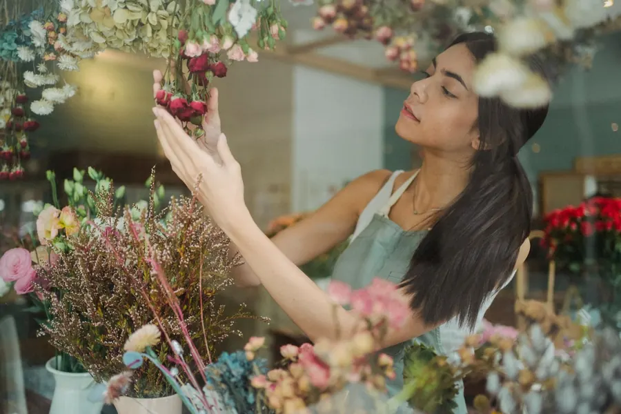 A florist arranging flowers in her shop